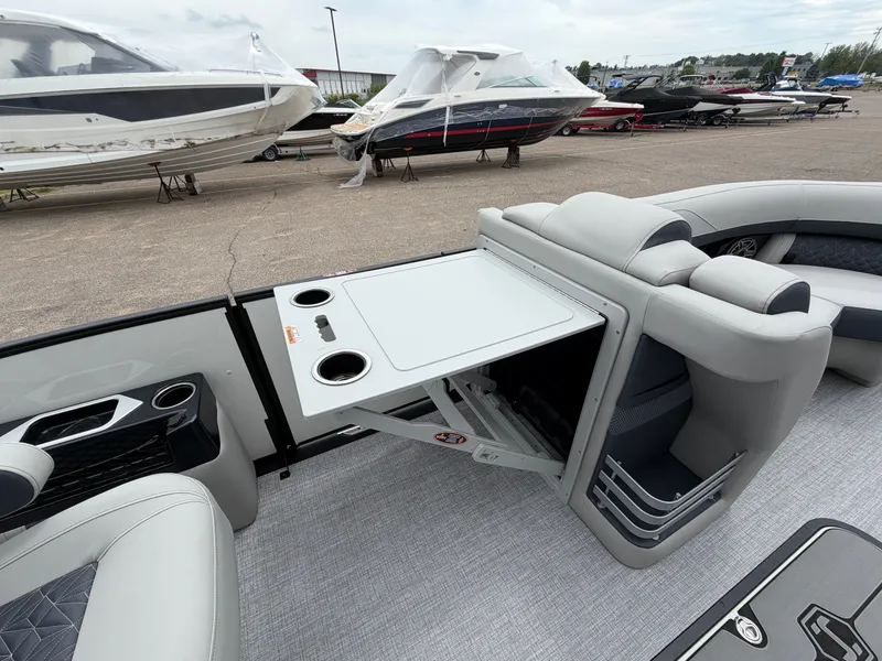 Slide: The Image of Interior of 2026 Harris Grand Mariner 230 boat with fold-out table. - 26