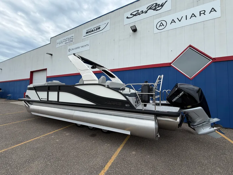 Slide: The Image of 2026 Harris Grand Mariner 230 pontoon boat outside a showroom. - 4