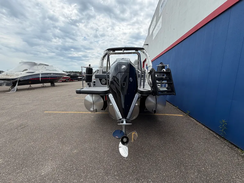 Slide: The Image of Harris Grand Mariner 230 boat, 2026 model, parked outdoors. - 6