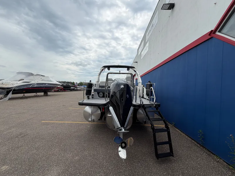 Slide: The Image of Harris Grand Mariner 230 boat, 2026 model, parked outdoors. - 7