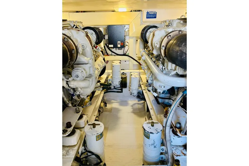 Slide: The Image of Engine room of a 2004 Viking 45 Convertible yacht, showcasing dual engines and mechanical components. - 13