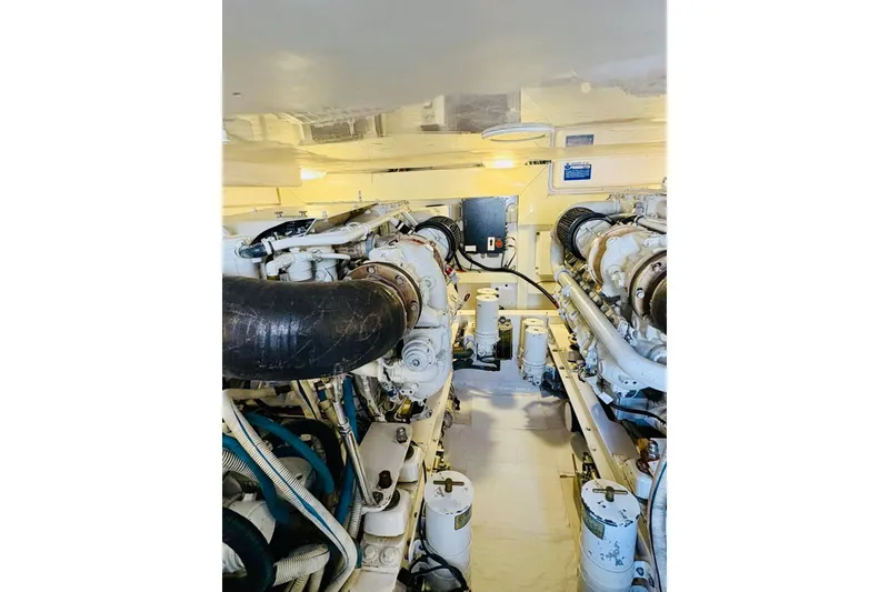 Slide: The Image of Engine room of 2004 Viking 45 Convertible yacht, showcasing dual engines and mechanical components. - 14