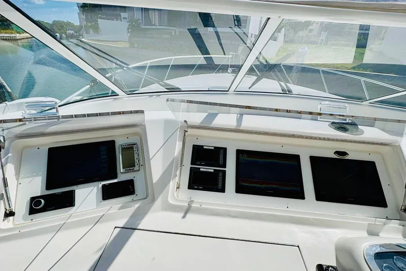 Slide: The Image of Control panel of a 2004 Viking 45 Convertible yacht with navigation screens and instruments. - 7