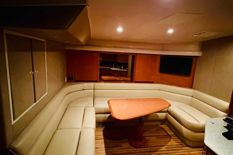 Slide: The Image of Luxurious interior of 2004 Viking 45 Convertible yacht with plush seating and wooden table. - 8