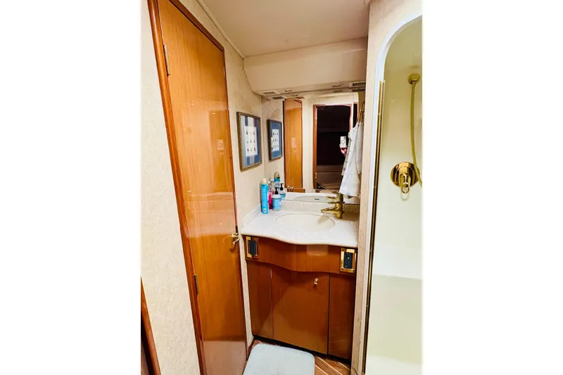 Slide: The Image of Luxurious bathroom in 2004 Viking 45 Convertible yacht with wooden cabinetry and modern fixtures. - 10