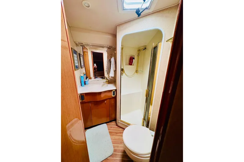 Slide: The Image of Bathroom interior of 2004 Viking 45 Convertible yacht, featuring shower and vanity. - 11