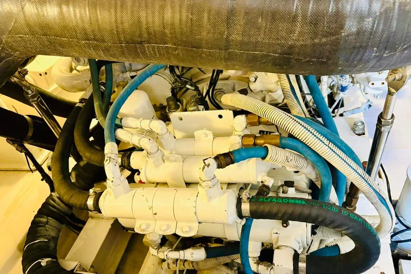 Slide: The Image of Engine room of 2004 Viking 45 Convertible with complex piping and hoses. - 16