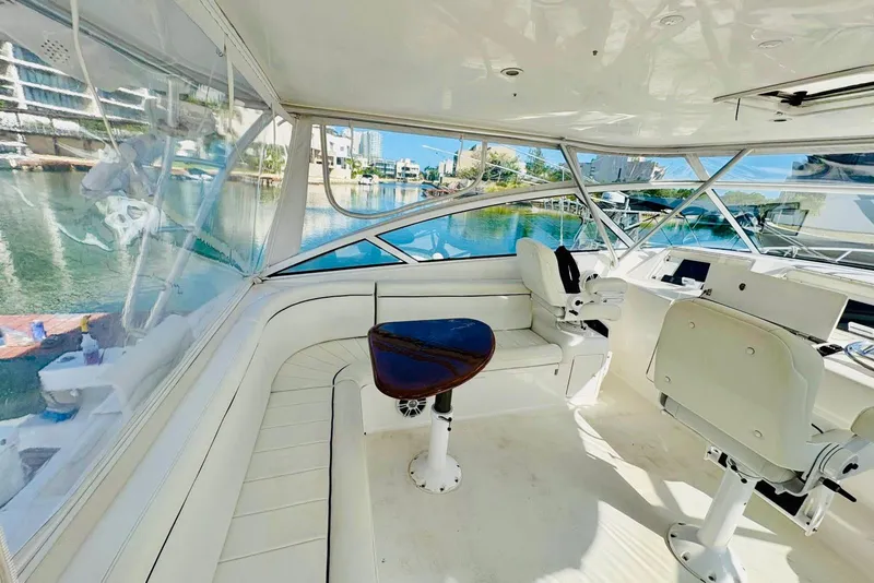 Slide: The Image of 2004 Viking 45 Convertible yacht interior with helm, seating, and waterfront view. - 4