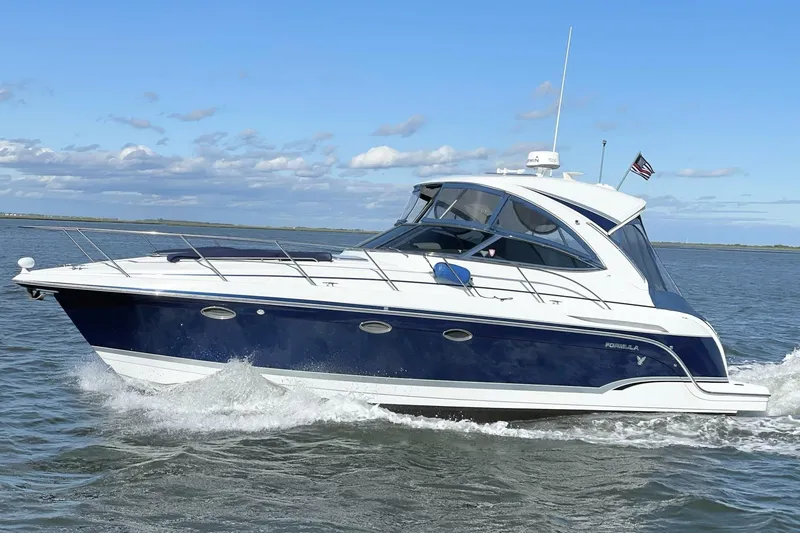 Slide: The Image of 2008 Formula 34 Performance Cruiser navigating on open water under a clear blue sky. - 2