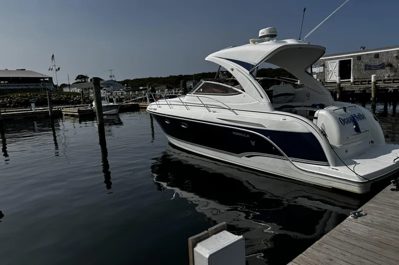 Slide: The Image of 2008 Formula 34 Performance Cruiser docked at a marina, reflecting on calm water. - 4