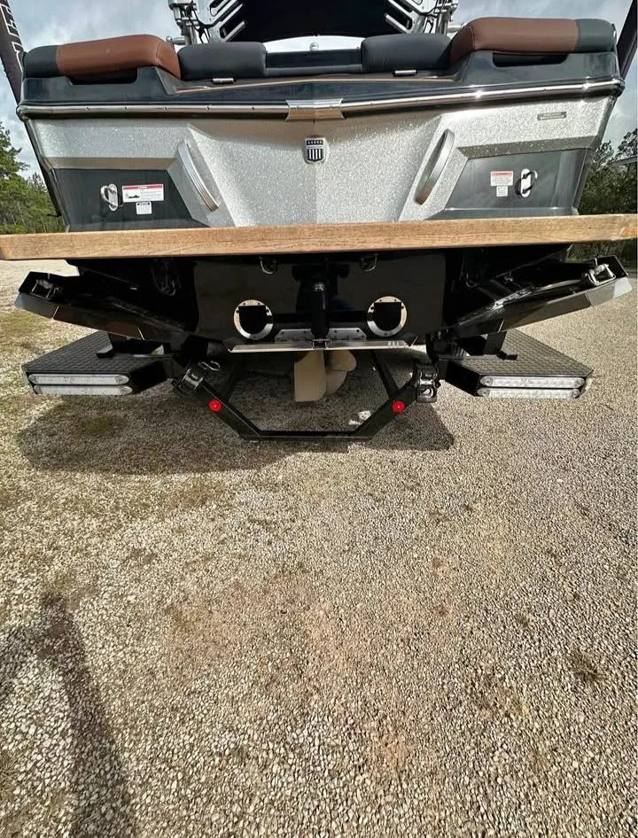 Slide: The Image of 2021 MasterCraft XT22 boat rear view with swim platform and dual exhaust. - 8