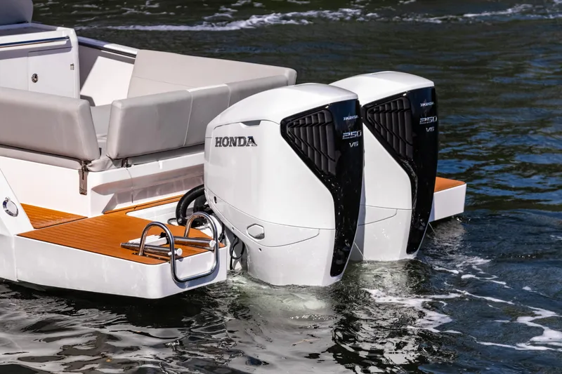 Slide: The Image of Twin Honda outboard engines on a 2025 STERK 31 boat, featuring sleek design and modern seating. - 6