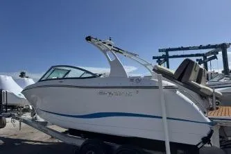 Slide: The Image of 2019 Bryant Calandra 23 boat on trailer under clear blue sky. - 3