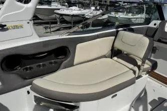 Slide: The Image of 2019 Bryant Calandra 23 boat interior with beige seating and cup holders. - 5