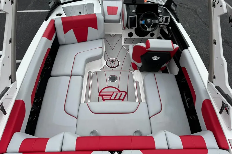 Slide: The Image of 2023 Malibu Wakesetter 20 VTX interior with red and gray seating, modern dashboard. - 11