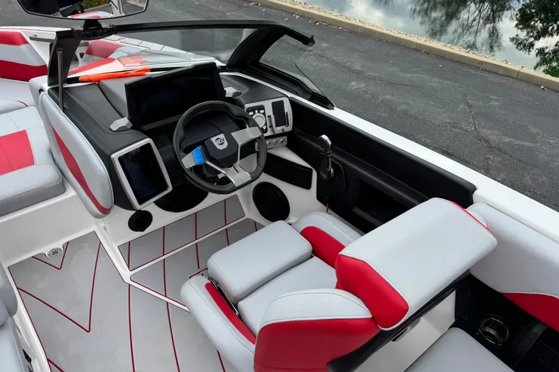 Slide: The Image of 2023 Malibu Wakesetter 20 VTX boat interior with modern dashboard and red accents. - 14