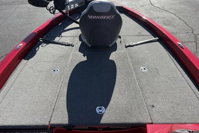 Slide: The Image of Red 2017 Phoenix 919 ProXP boat interior with gray carpet and branding details. - 15