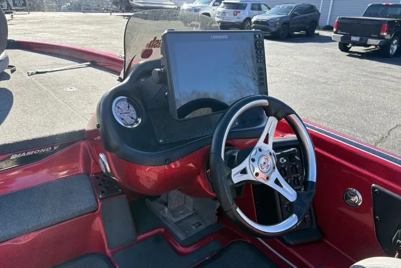 Slide: The Image of 2017 Phoenix 919 ProXP boat interior with red and gray seats, steering wheel, and carpeted deck. - 22