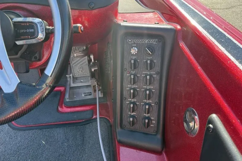 Slide: The Image of 2017 Phoenix 919 ProXP boat dashboard with steering wheel and navigation display. - 26