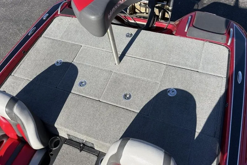 Slide: The Image of 2017 Phoenix 919 ProXP boat deck with red accents and motor components. - 28