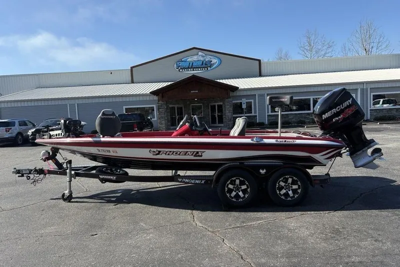 Slide: The Image of 2017 Phoenix 919 ProXP fishing boat with red and gray seating, equipped with Lowrance electronics. - 33