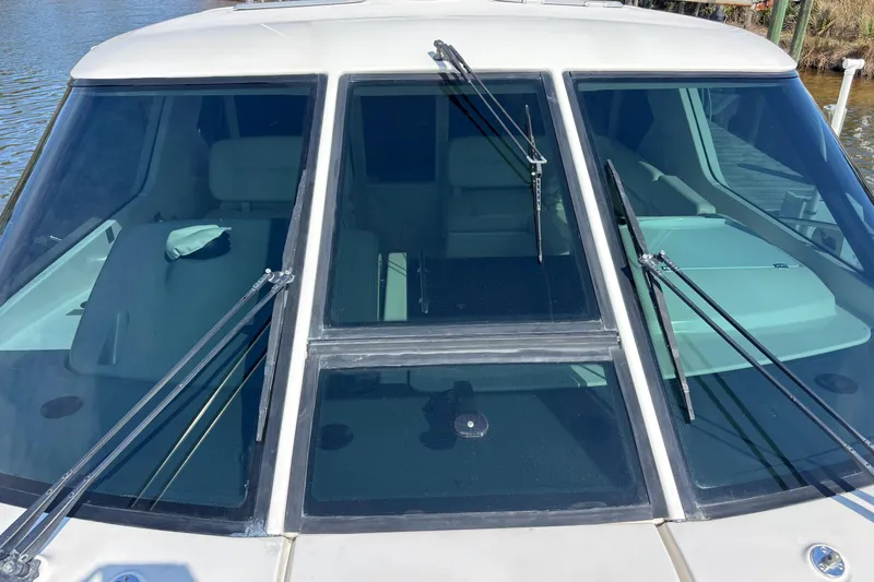 Slide: The Image of 2004 Tiara Yachts 3600 Sovran windshield with wipers, docked on calm water. - 10