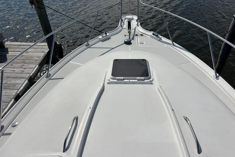 Slide: The Image of 2004 Tiara Yachts 3600 Sovran bow view, docked by the water. - 11