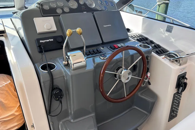 Slide: The Image of Helm of 2004 Tiara Yachts 3600 Sovran with steering wheel and navigation controls. - 16