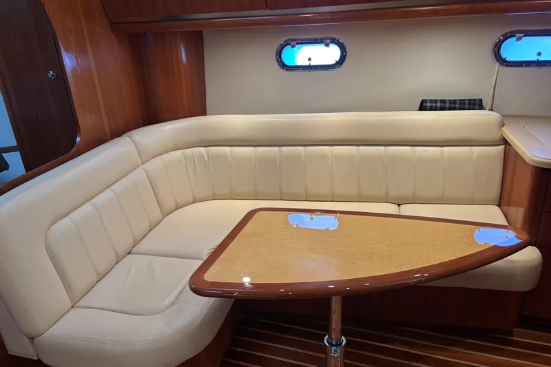 Slide: The Image of Luxurious interior of 2004 Tiara Yachts 3600 Sovran with plush seating and wooden table. - 23