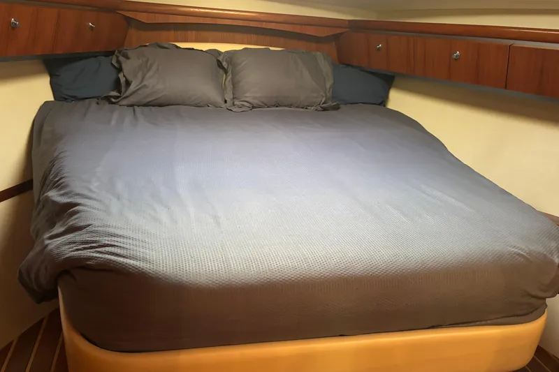 Slide: The Image of Luxurious cabin interior of 2004 Tiara Yachts 3600 Sovran with cozy bed and wooden accents. - 25