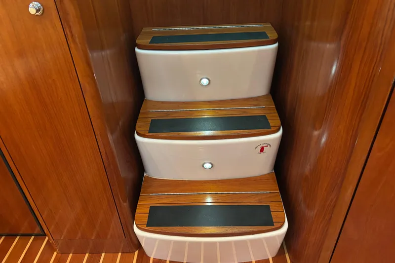 Slide: The Image of Wooden steps inside a 2004 Tiara Yachts 3600 Sovran, featuring sleek design and lighting. - 27