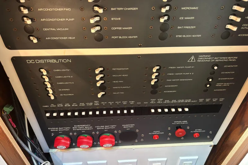 Slide: The Image of Electrical control panel of a 2004 Tiara Yachts 3600 Sovran, featuring various switches and indicators. - 32