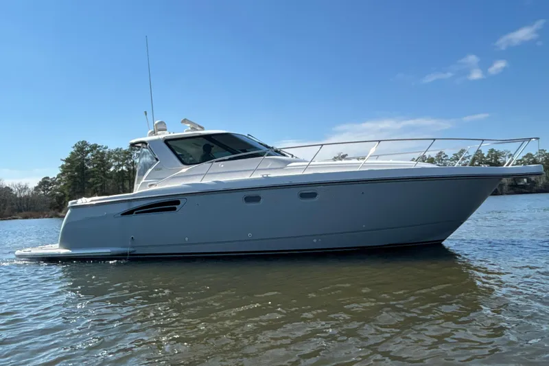 Slide: The Image of 2004 Tiara Yachts 3600 Sovran cruising on a calm lake under a clear blue sky. - 4