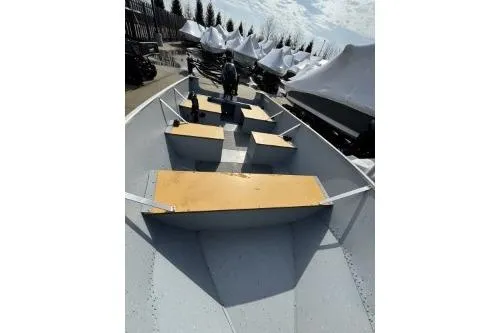 Slide: The Image of 2023 Lund SSV-14 Tiller boat with wooden seats, docked outdoors. - 15