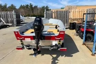 Slide: The Image of 2023 Lund SSV-14 Tiller boat with outboard motor in a storage area. - 6