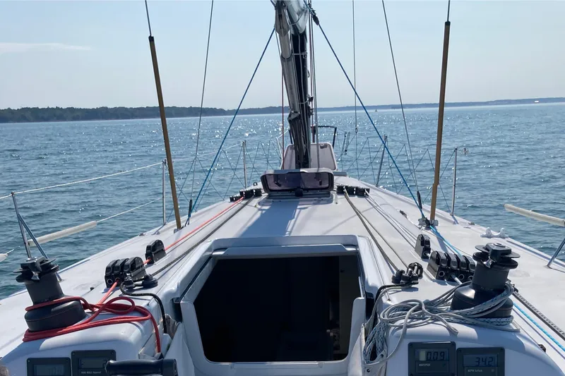 Slide: The Image of Sailing on a 1995 Tripp 47 yacht, open sea view, clear skies. - 13