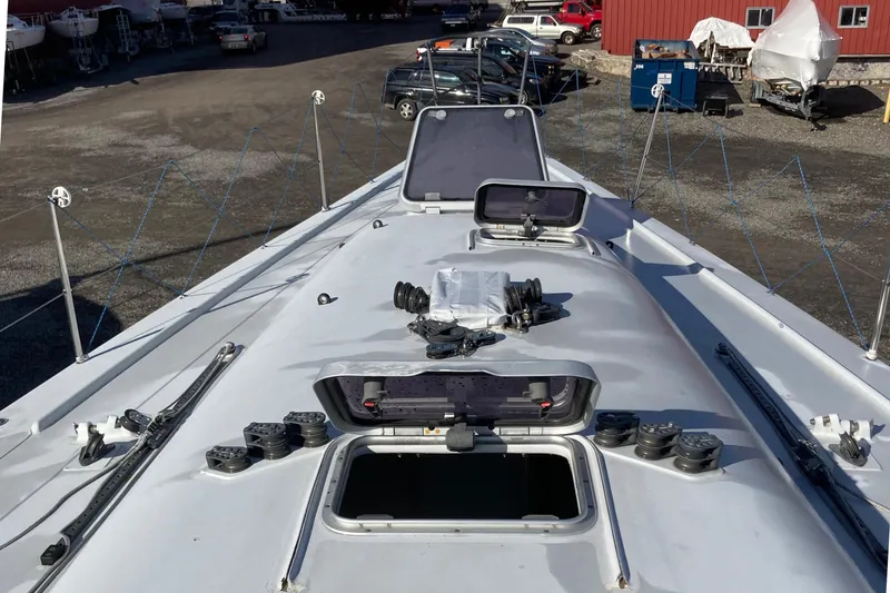 Slide: The Image of Deck view of a 1995 Tripp 47 sailboat with open hatches and rigging details. - 17