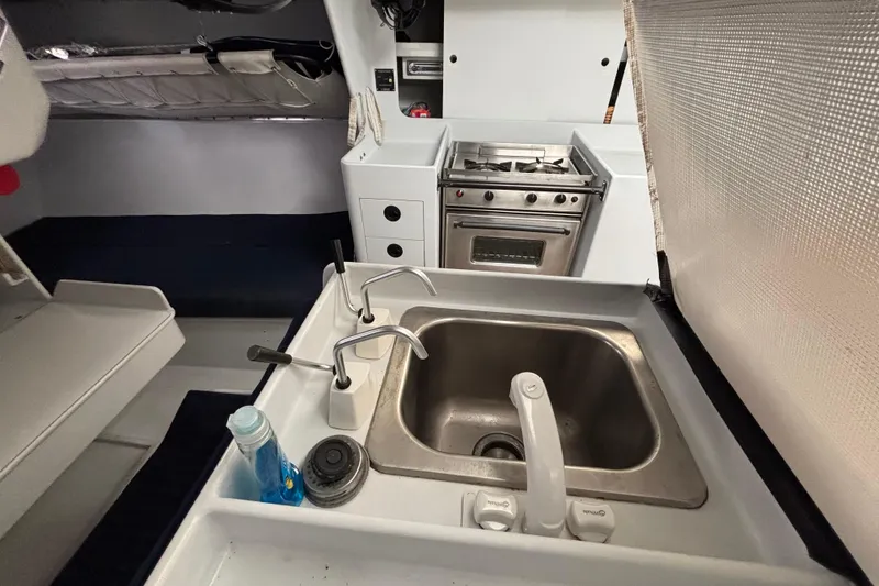 Slide: The Image of Compact kitchen area in a 1995 Tripp 47 sailboat with sink and stove. - 19