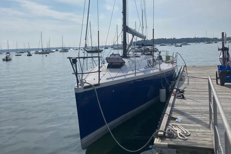 Slide: The Image of Sailboat docked at marina, Tripp 47 model, 1995, calm waters, clear sky. - 2