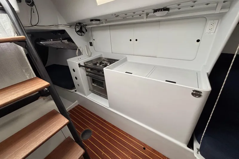 Slide: The Image of Compact kitchen area in a 1995 Tripp 47 sailboat with stove and storage. - 20