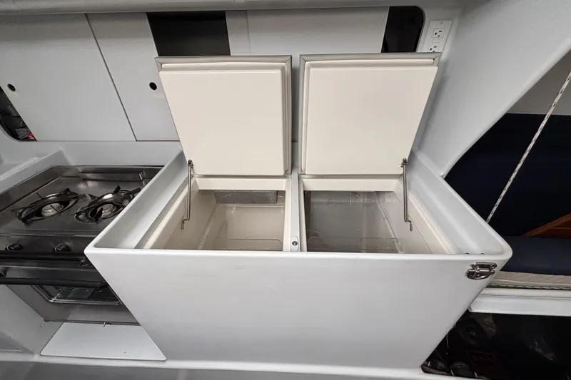 Slide: The Image of Kitchen area of a 1995 Tripp 47 yacht with open storage compartments. - 22