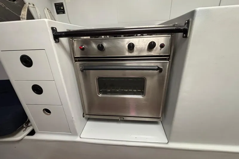 Slide: The Image of Stainless steel oven in a 1995 Tripp 47 yacht kitchen setup. - 23