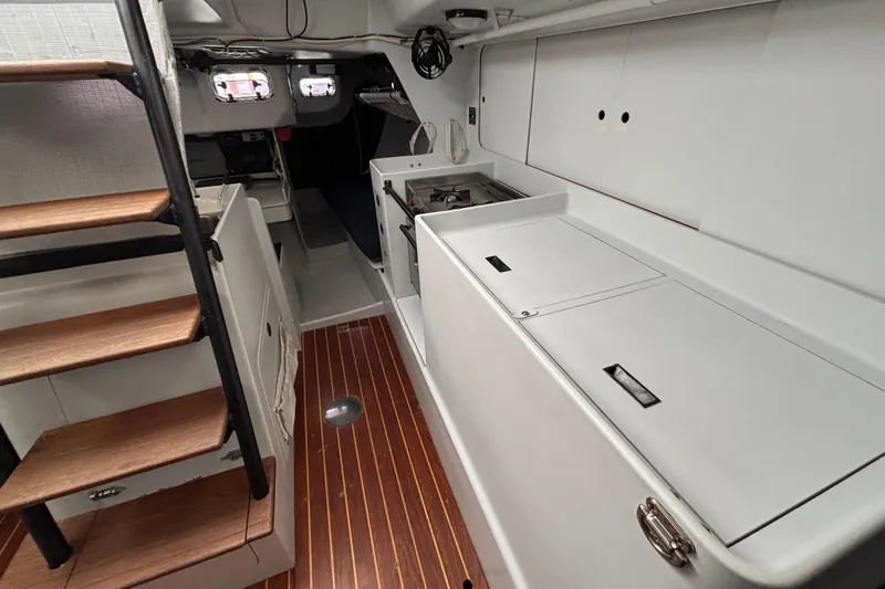 Slide: The Image of Interior of a 1995 Tripp 47 yacht with wooden stairs and sleek white cabinetry. - 26