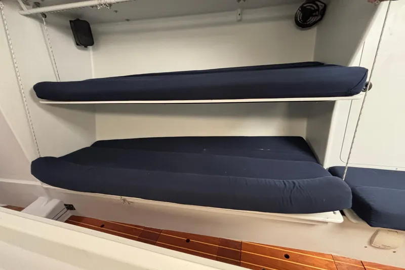 Slide: The Image of Bunk beds with navy cushions in a 1995 Tripp 47 sailboat interior. - 30