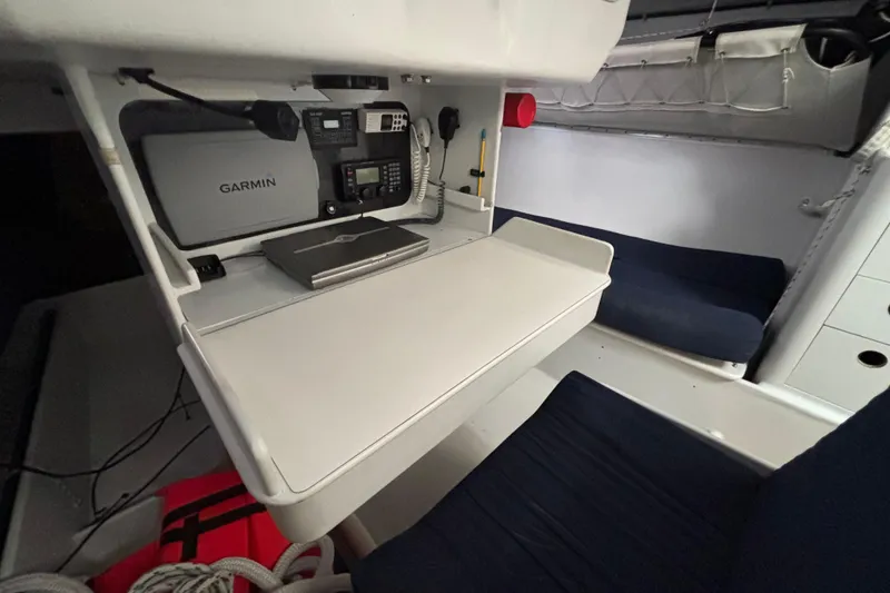 Slide: The Image of Navigation station inside a 1995 Tripp 47 yacht with Garmin equipment and seating area. - 31