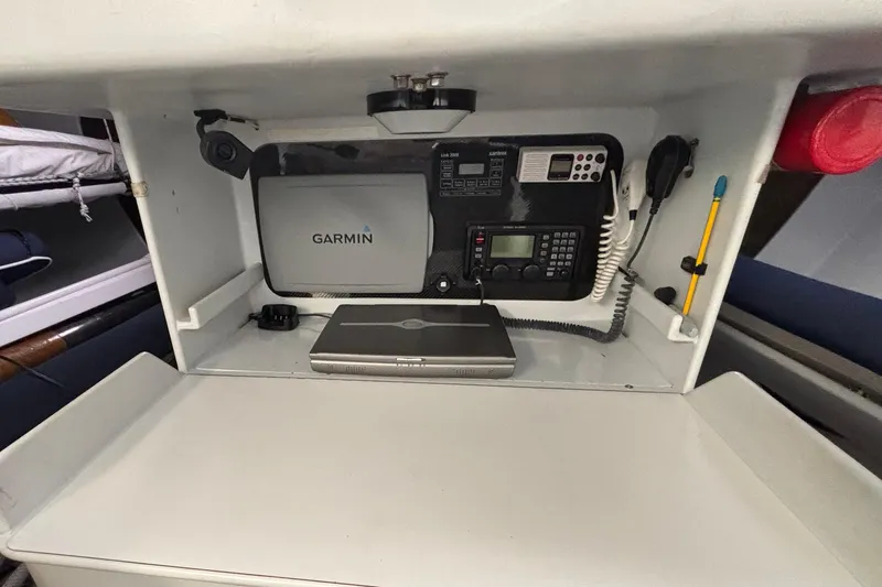 Slide: The Image of Navigation equipment setup in a 1995 Tripp 47 sailboat, featuring Garmin devices. - 32
