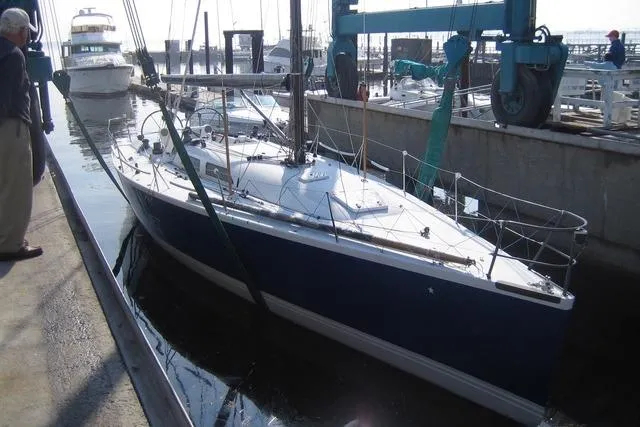 Slide: The Image of Sailboat in dock, Tripp 47 model, 1995, with blue hull and white deck. - 4