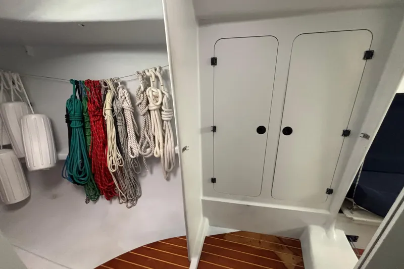 Slide: The Image of Storage area on a 1995 Tripp 47 sailboat with ropes and fenders neatly organized. - 40