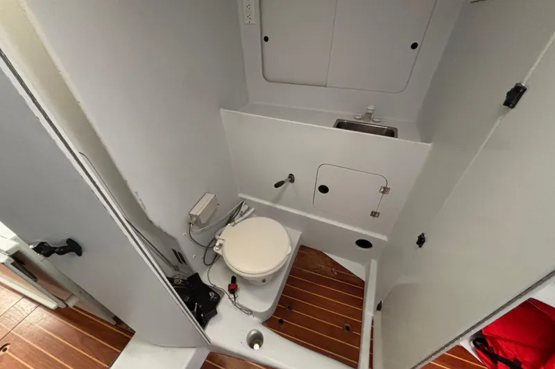 Slide: The Image of Compact bathroom in a 1995 Tripp 47 boat with toilet and sink. - 41