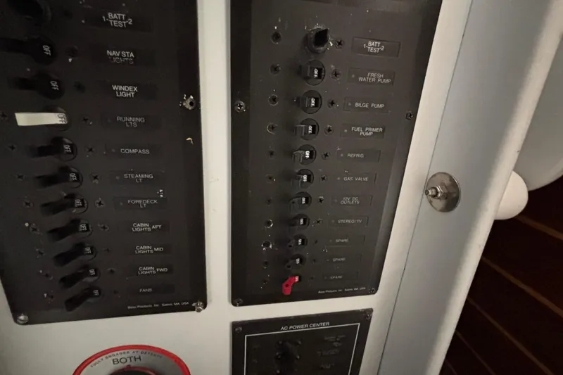 Slide: The Image of Control panel of a 1995 Tripp 47 boat, featuring various switches and labels. - 42